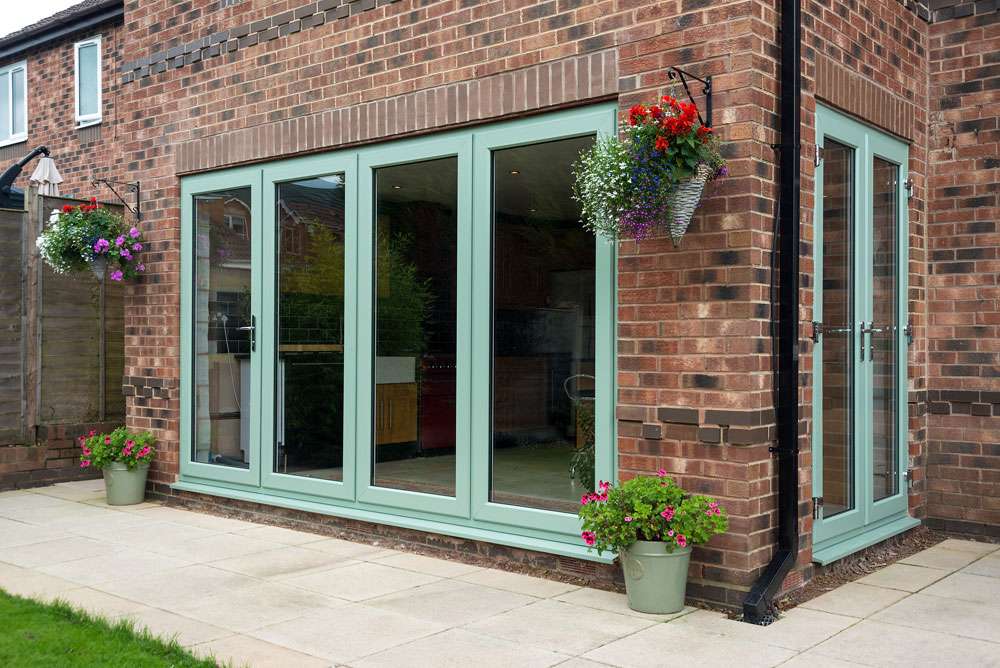 green easifold doors on brick house