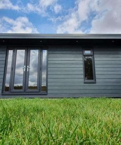 Anthracite grey french doors with side panels on annex